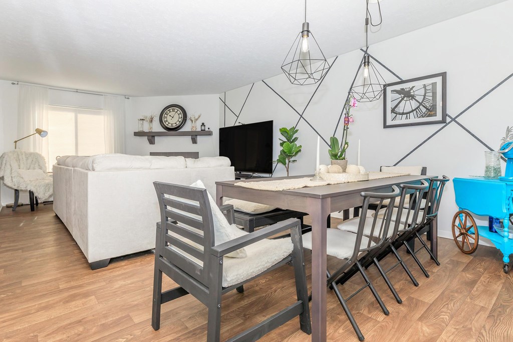 A dining room with a table and chairs.