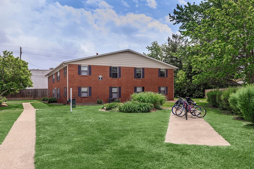 A red brick building with a bicycle parked in front.