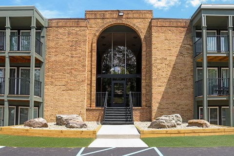 A building with a large arched entrance and a brick facade.