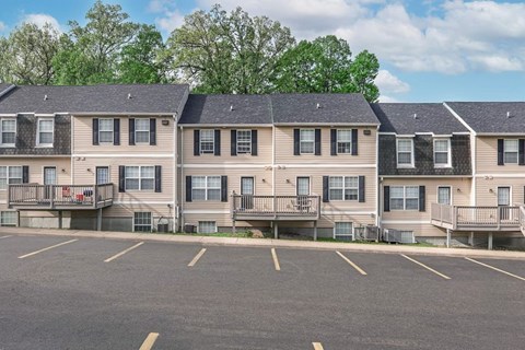 A parking lot in front of apartment buildings.