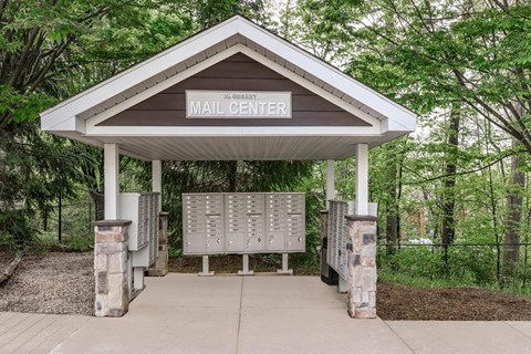 A mailbox is located under a roof with the words "Mail Center" on it.