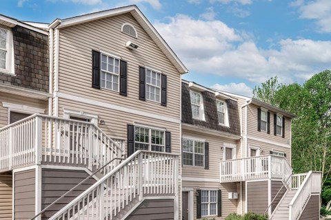 A multi-story residential building with a balcony on each floor.