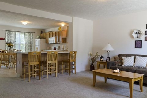A dining room with a table and chairs.