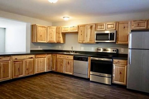 A kitchen with wooden cabinets and stainless steel appliances.