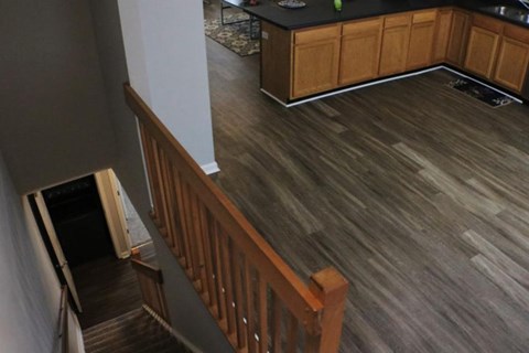 A kitchen with wooden cabinets and a black countertop.