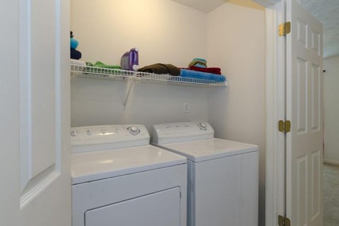 A small laundry room with a washer and dryer.