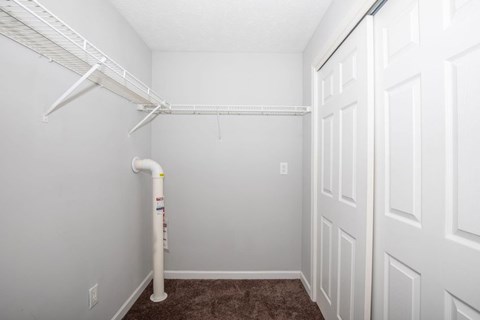 A white pipe runs along the wall of a room.
