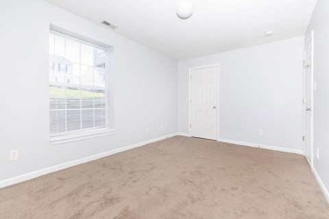 A room with a window and a door.