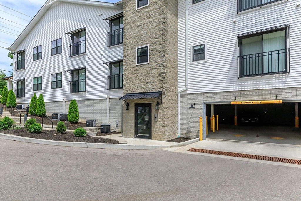A white building with a black garage door.