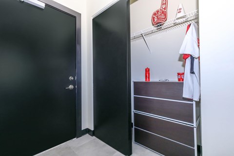 A black door is on the left and a white towel is hanging on a rack on the right.