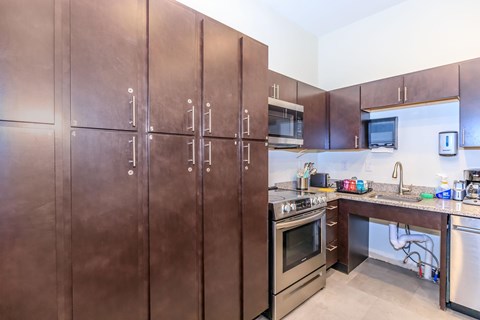 A kitchen with brown cabinets and stainless steel appliances.