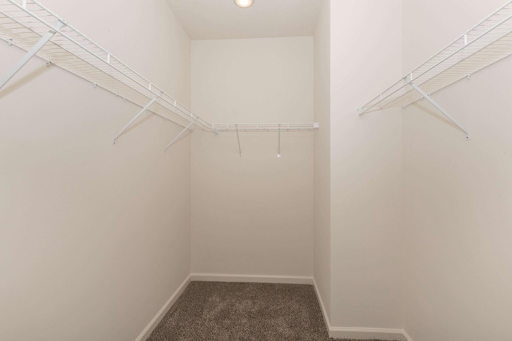 A small, empty room with a carpeted floor and white walls.