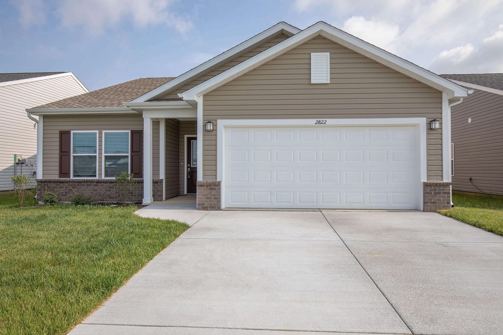 A house with a brown roof and a white garage door.