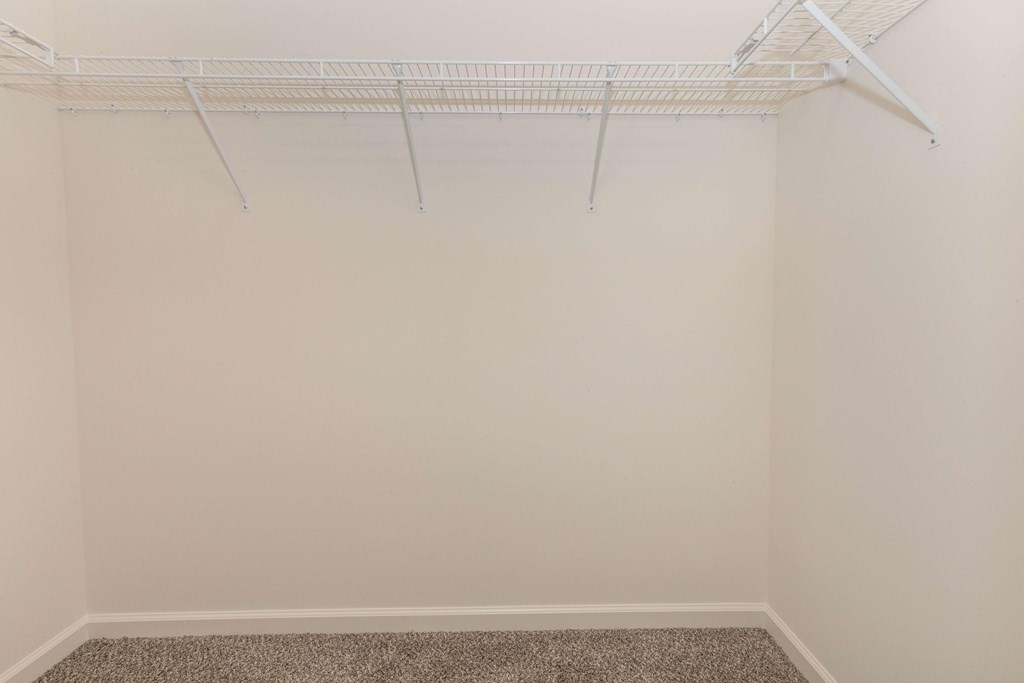 Empty room with a white closet rod.