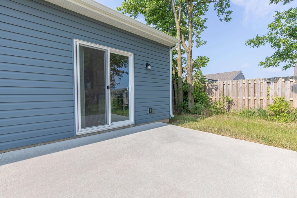 A blue house with a white door and window.