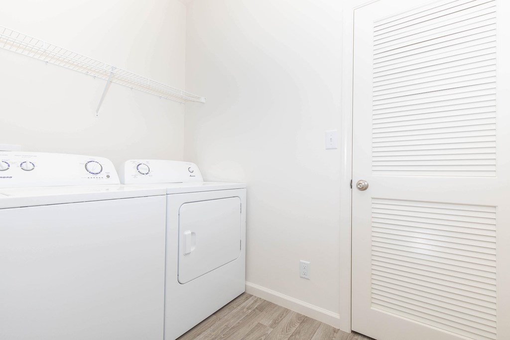 A white washer and dryer in a small laundry room.
