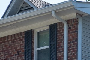 the front entrance of a brick building with a driveway