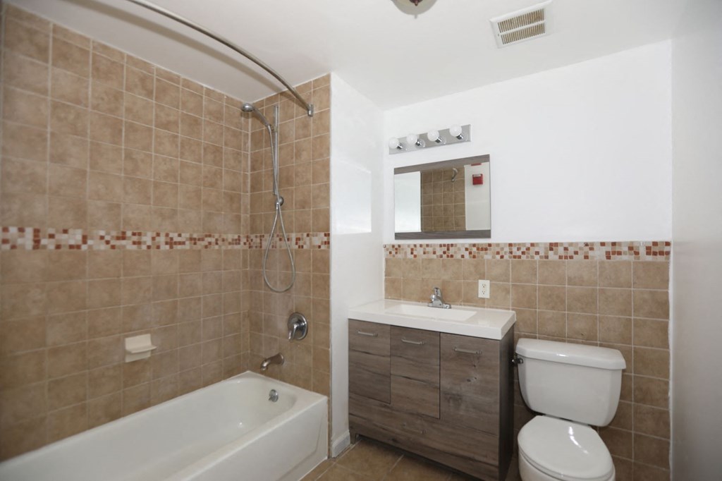 a bathroom with a toilet sink and a bath tub