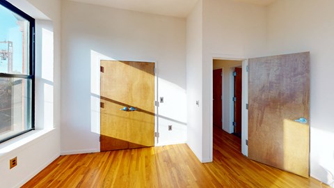 a living room with a wood floor and a door in a room