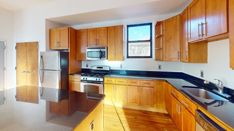 a kitchen with wooden cabinets and a stove and a refrigerator