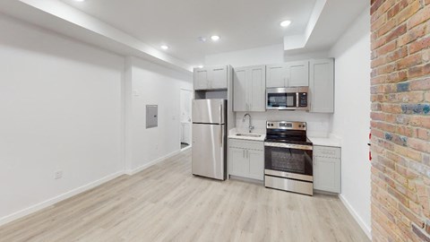 a kitchen with a stove top oven next to a refrigerator