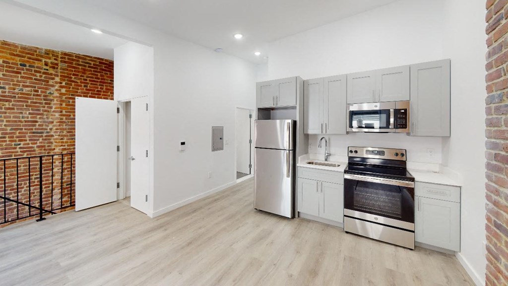 a kitchen with a stove top oven next to a refrigerator