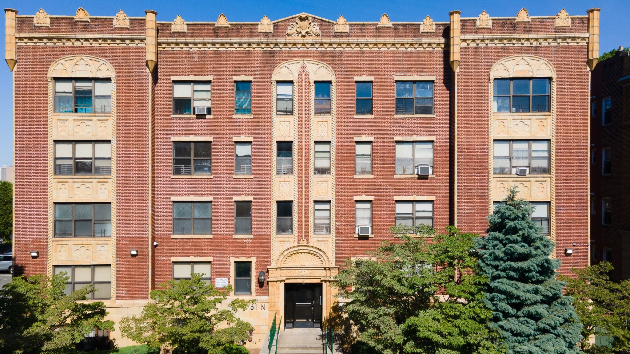 a large brick building with trees in front of it