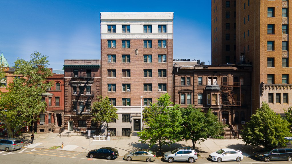 an aerial view of a brick building in a city street