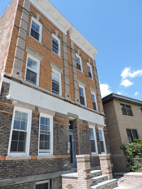 a brick building with a blue sky in the background