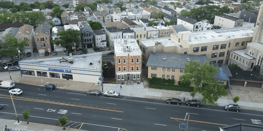 arial view of a city street with cars parked on the side of the road