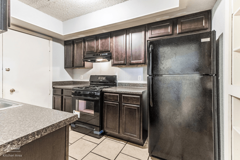 a kitchen with stainless steel appliances and wooden cabinets