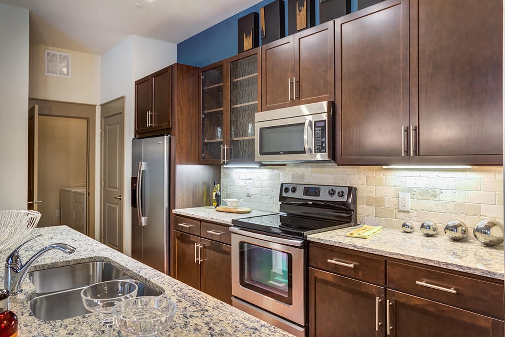 a kitchen with stainless steel appliances and granite counter tops