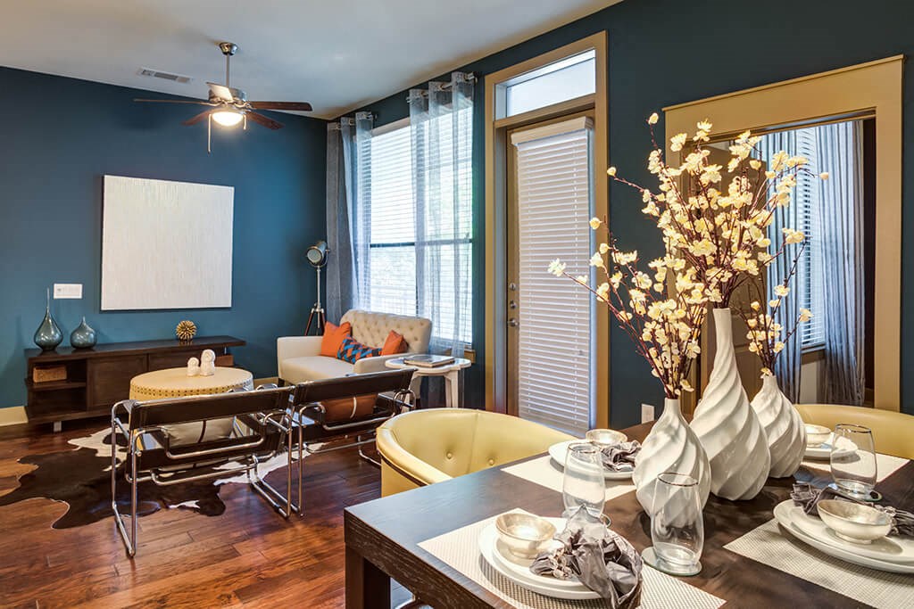 a dining room with a table and chairs and a living room