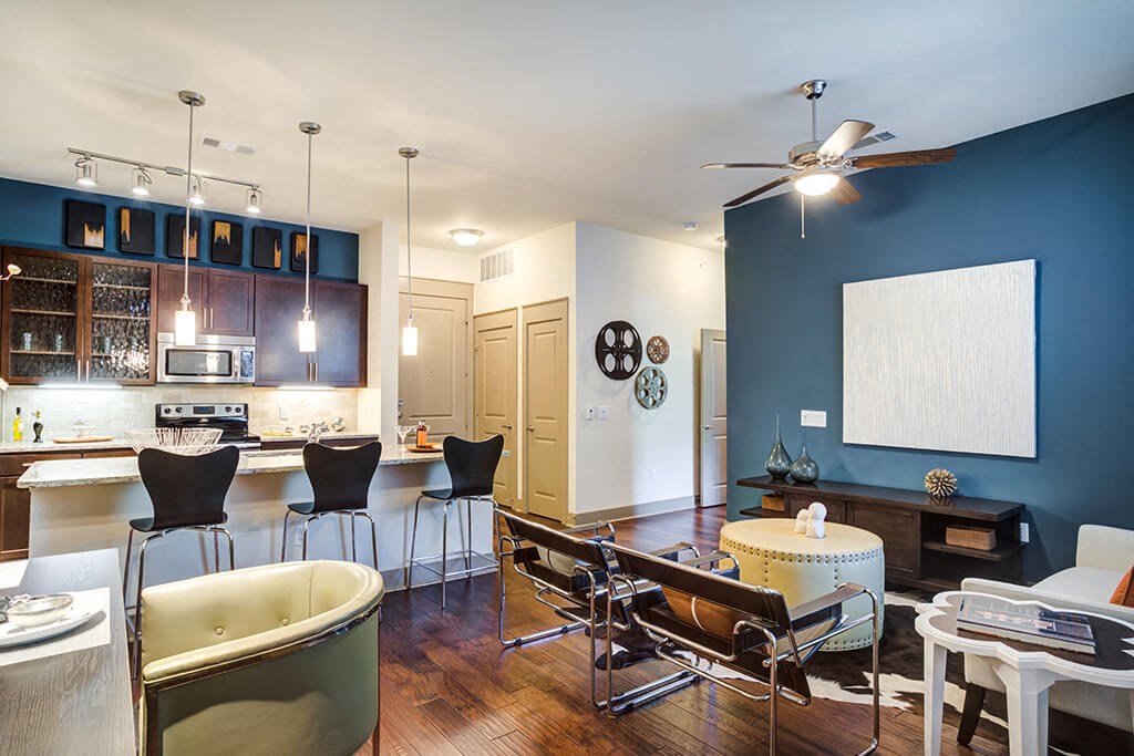 a living room and kitchen with a table and chairs