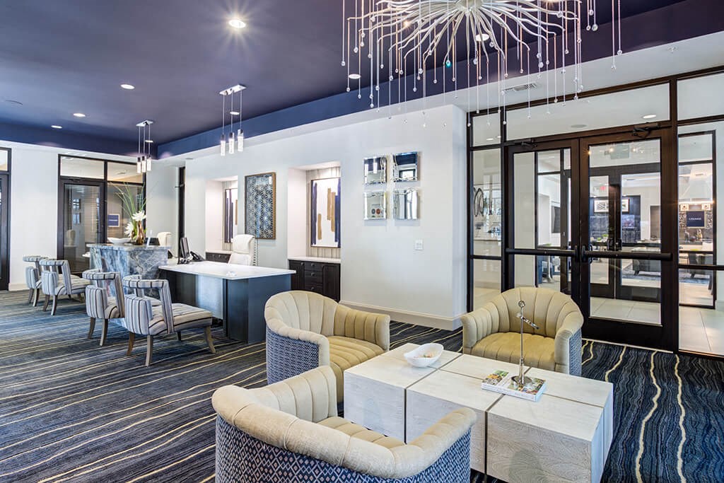 a lobby with couches and chairs and a table