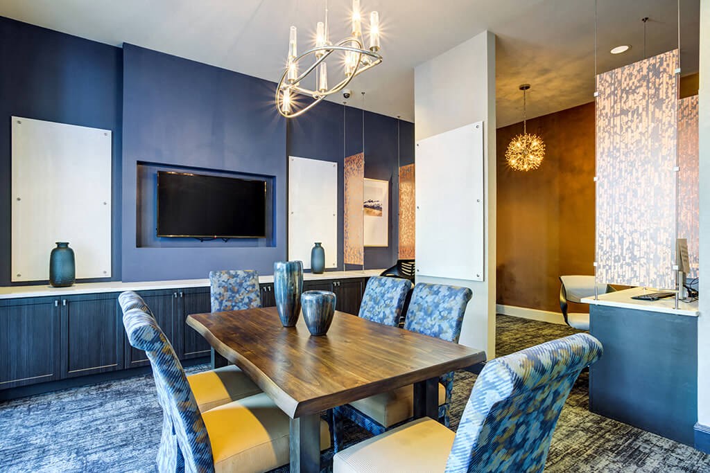 a dining room with a table and chairs and a television