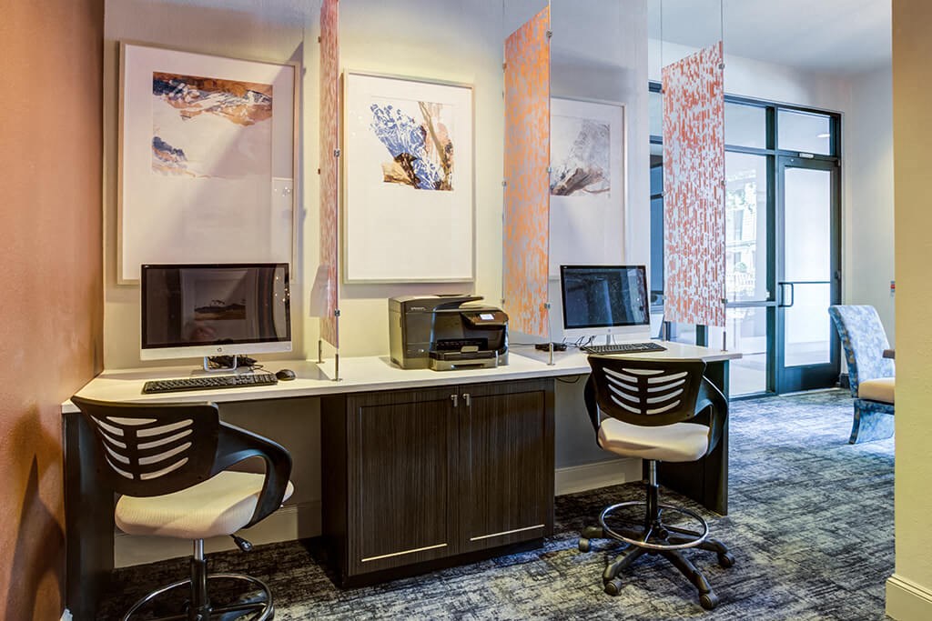 an office with two desks and a computer and a printer