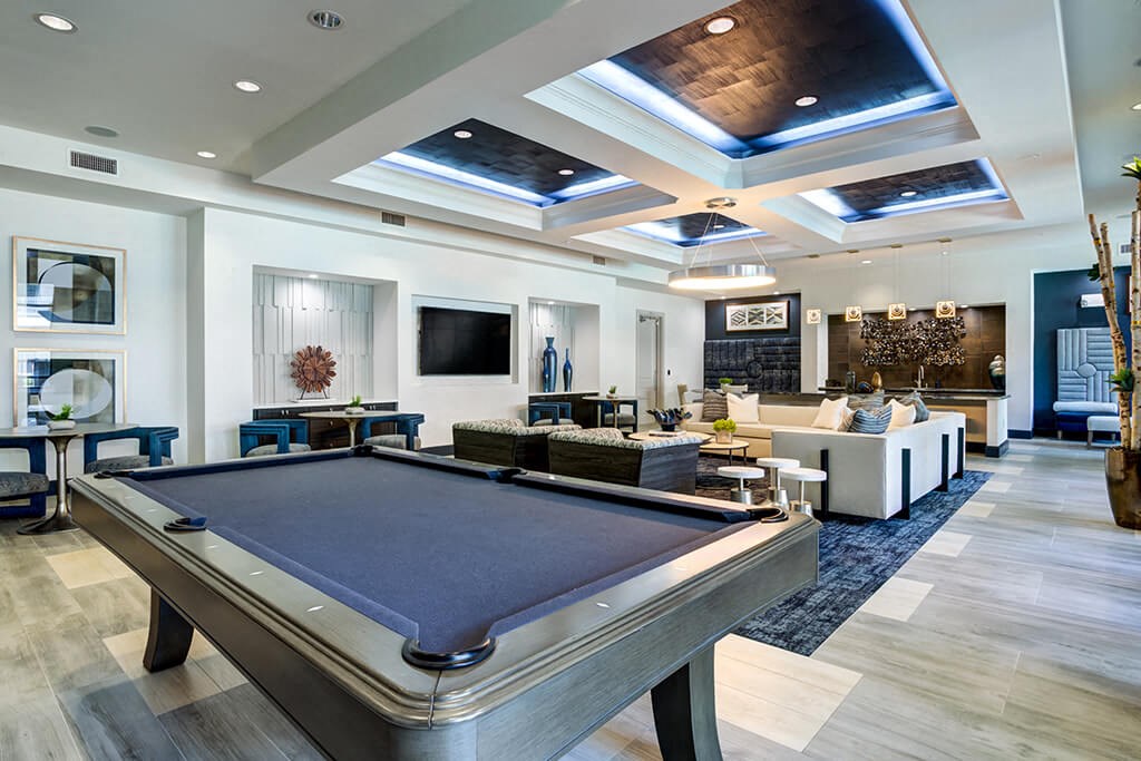 a game room with a pool table and a television