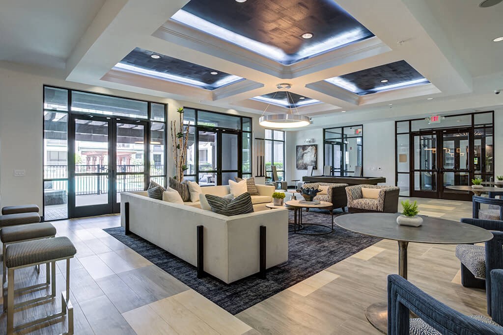 a lobby with couches and chairs and a table