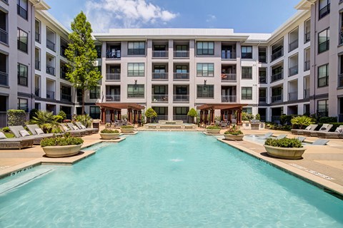 a swimming pool in front of an apartment building