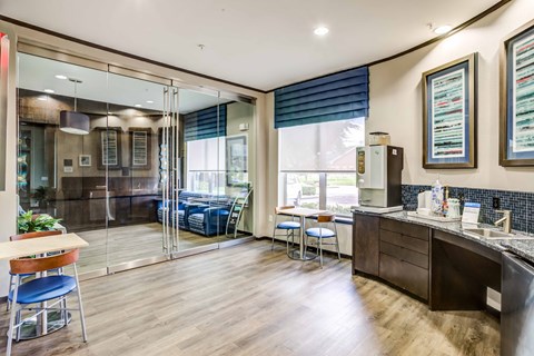 a kitchen and living room with a counter and a refrigerator