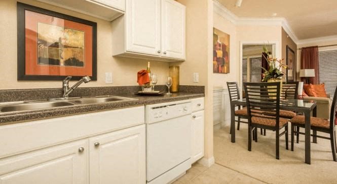 a kitchen with a sink and a dining table