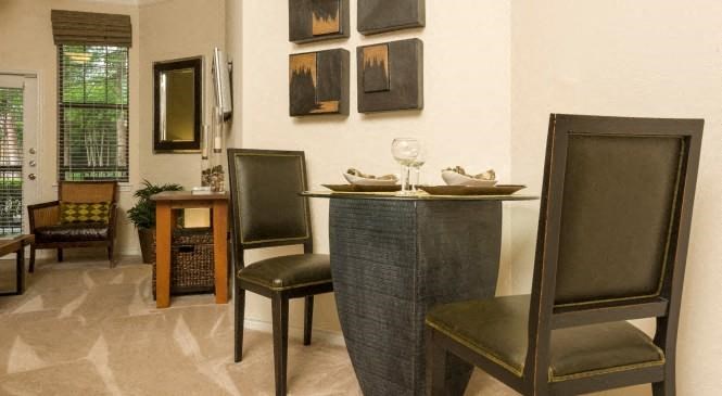 a dining room with a table and chairs