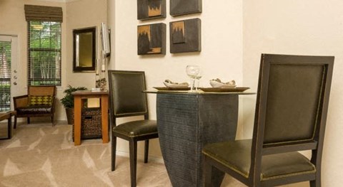 a dining room with a table and chairs