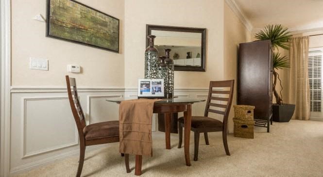 a dining room with a table and chairs