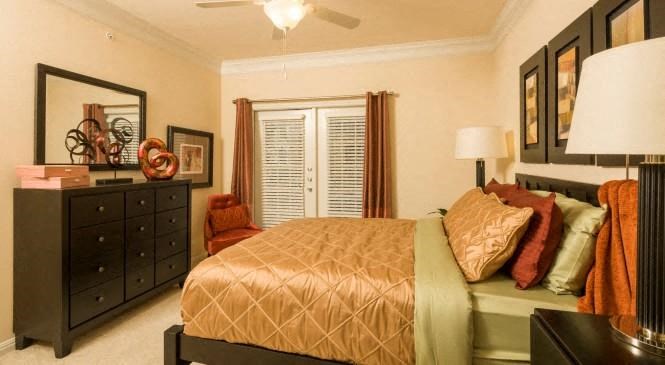 a bedroom with a bed and a dresser