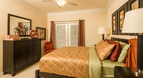 a bedroom with a bed and a dresser