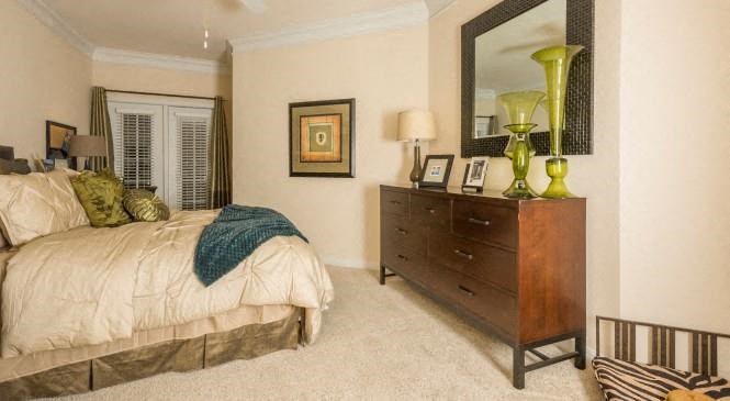 a bedroom with a bed and a dresser
