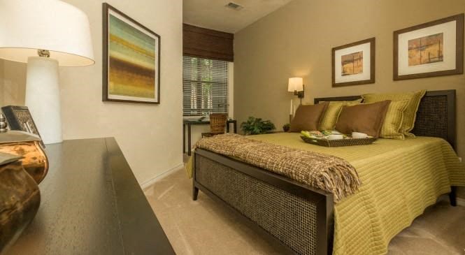 a bedroom with a bed and a desk