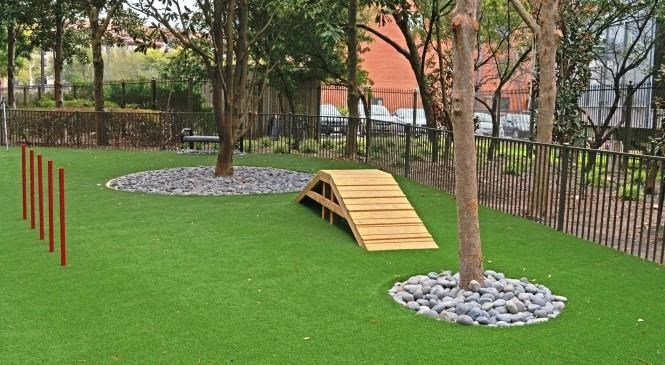 a park with a wooden structure in the grass